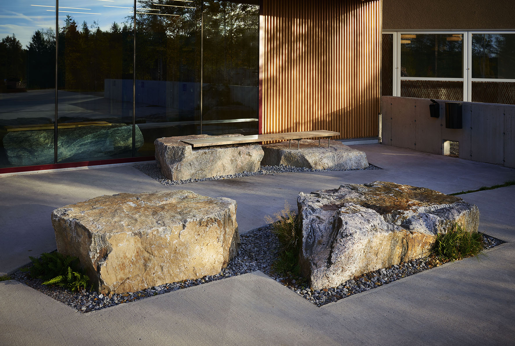 building with stone slabs surrounded by concrete